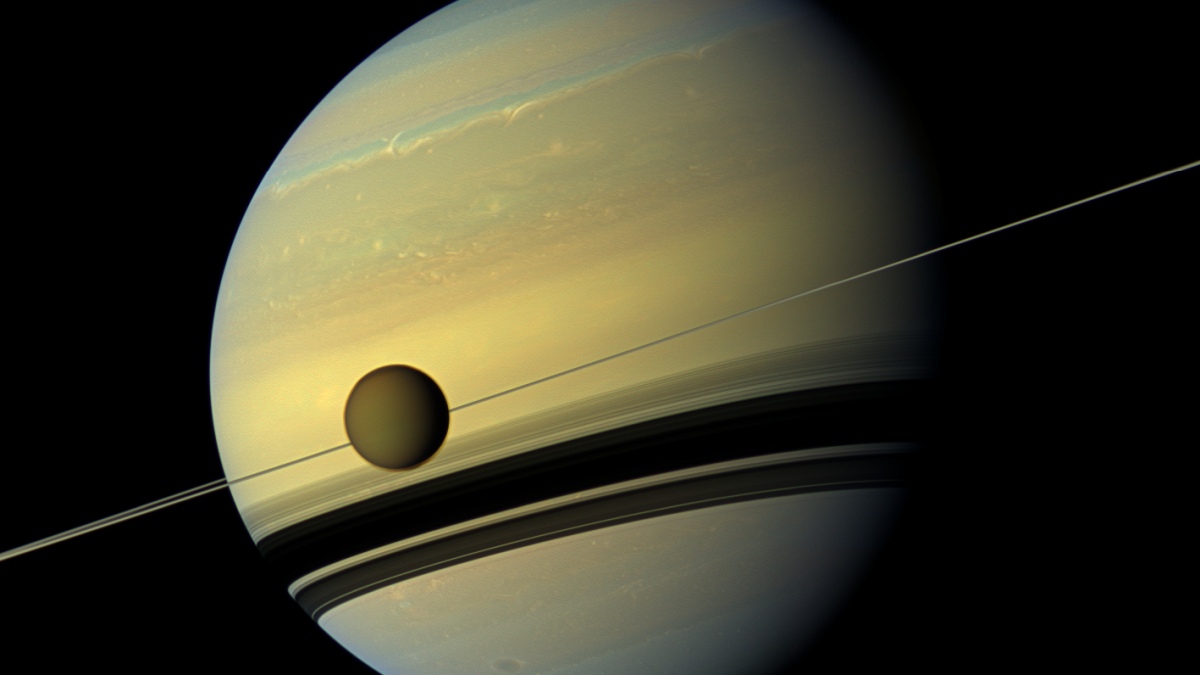 Saturn and one of its moons Titan.